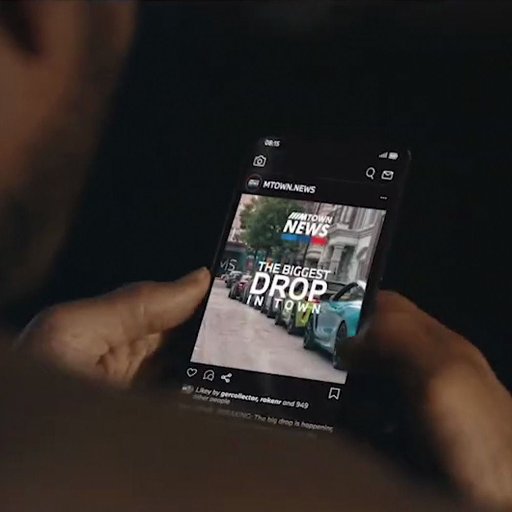 Smartphone showing M Town News app with The Biggest Drop in Town headline