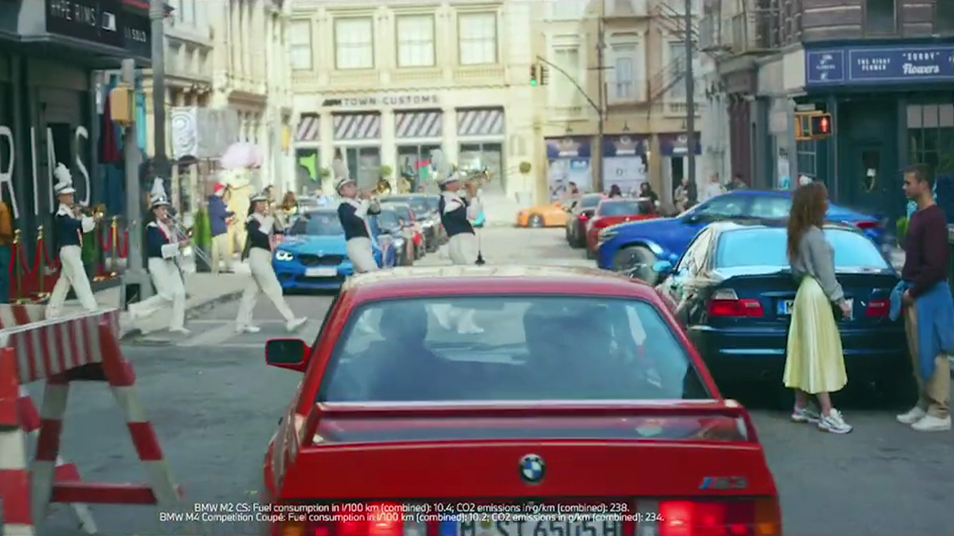 M Town street scene with various BMW M models and yellow detail boxes highlighting design elements