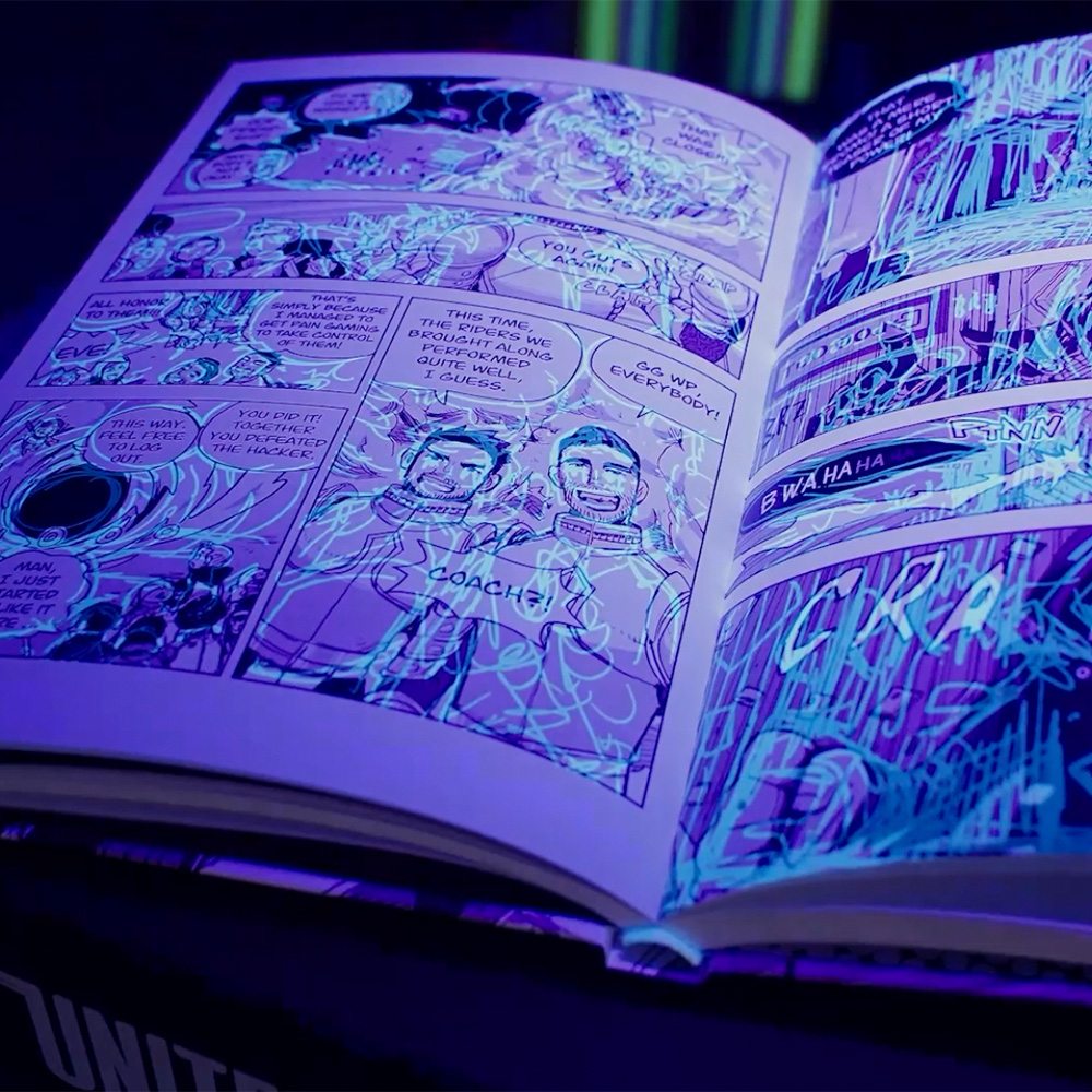 Open manga book under UV light revealing hidden artwork and sketches