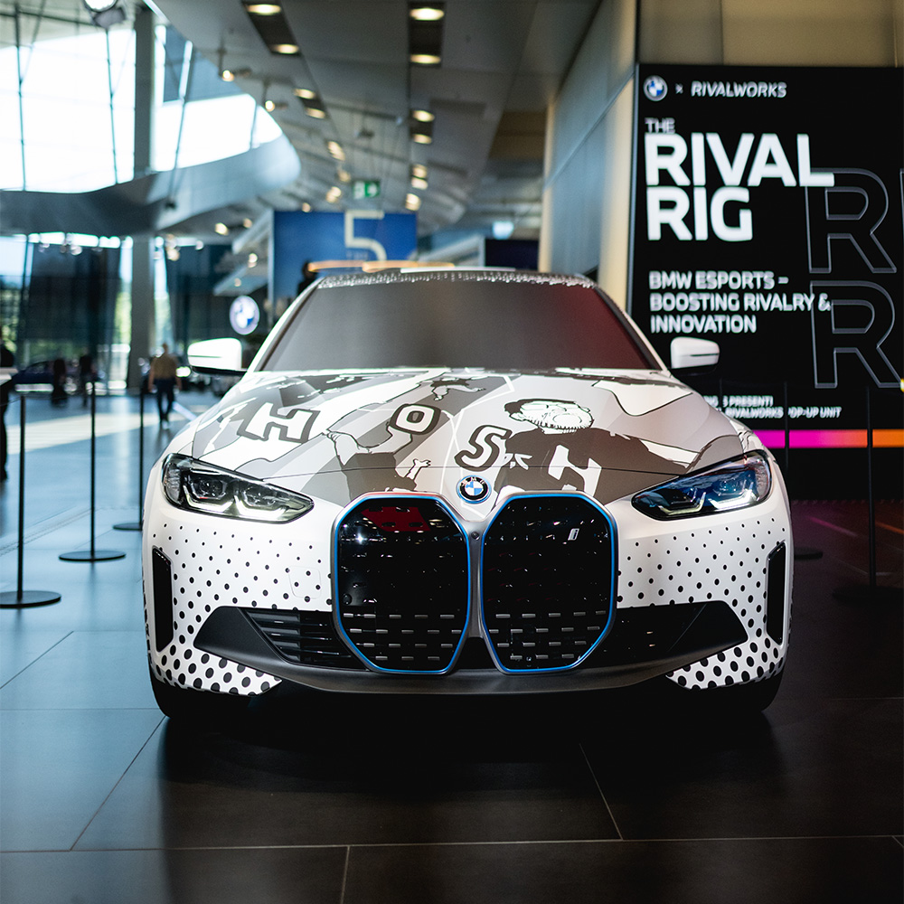 BMW i4 with Heroes of Rivalry manga livery wrap showing character artwork on white bodywork